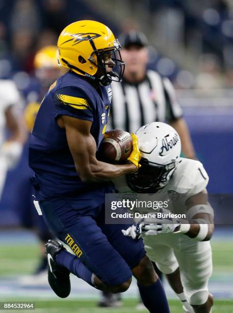 Wide receiver Jon'Vea Johnson of the Toledo Rockets catch a pass against cornerback Alvin Davis of the Akron Zips during the first half at Ford Field...