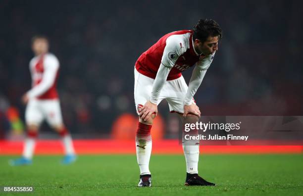 Mesut Ozil of Arsenal look dejected during the Premier League match between Arsenal and Manchester United at Emirates Stadium on December 2, 2017 in...