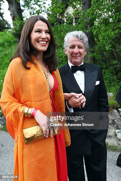 Sports television presenter Marcel Reif and his wife Marion Kiechle depart after attending the church wedding of former tennis star Boris Becker to...
