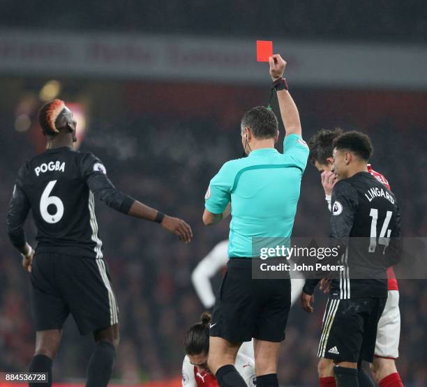 Paul Pogba of Manchester United is sent off by Referee Andre Marriner during the Premier League match between Arsenal and Manchester United at...