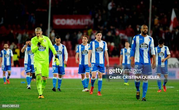 Deportivo La Coruna's players react during the Spanish league football match Sevilla FC vs RC Deportivo de la Coruna at the Ramon Sanchez Pizjuan...