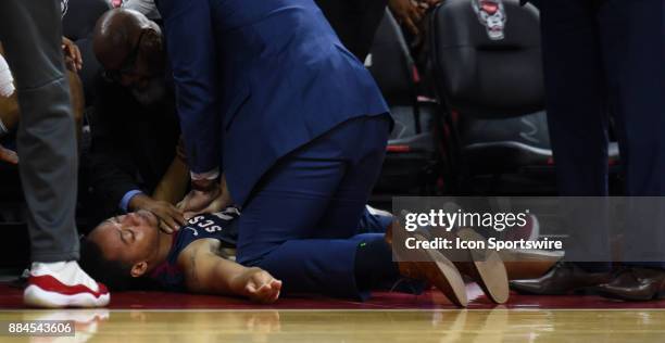 South Carolina State Bulldogs guard Ty Solomon is administered CPR after collapsing near the bench after an injury timeout during the game between...