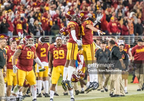 Trojans tight end Josh Falo and USC Trojans linebacker Levi Jones celebrate a win clinching 1st down play late in the fourth quarter during the...