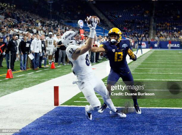 Wide receiver Austin Wolf of the Akron Zips catches a touchdown pass against defensive back Ka'dar Hollman of the Toledo Rockets during the second...