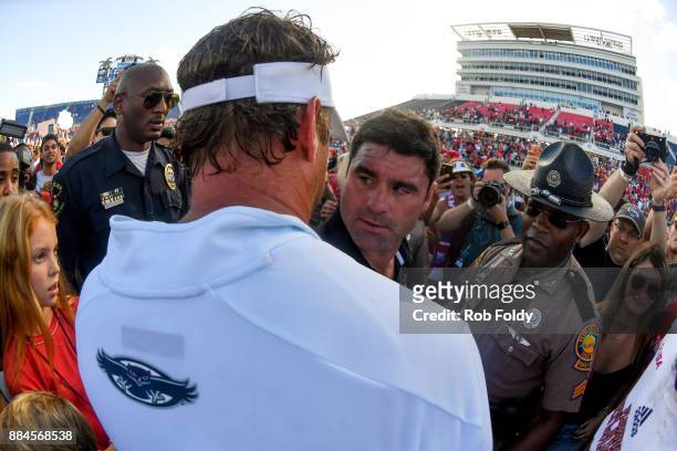 Head coaches Seth Littrell of the North Texas Mean Green and Lane Kiffin of the Florida Atlantic Owls shake hands after the Conference USA...
