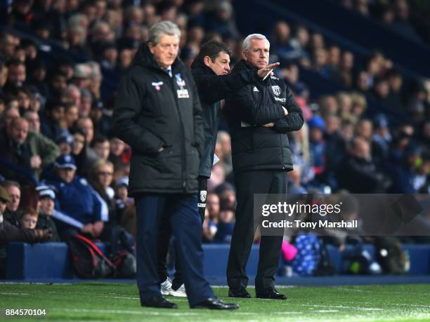 John Carver, First Team Coach and Alan Pardew, Manager of West Bromwich Albion on the touchline with Roy Hodgson, Manager of Crystal Palace during...