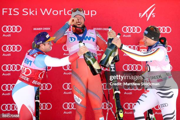 Beat Feuz of Switzerland, Aksel Lund Svindal of Norway and Thomas Dressen of Germany celebrate on the medals podium after the Men's Downhill during...