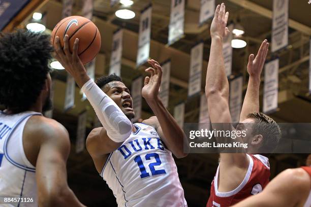 Javin DeLaurier of the Duke Blue Devils goes to the basket against Tyler Hagedorn of the South Dakota Coyotes at Cameron Indoor Stadium on December...