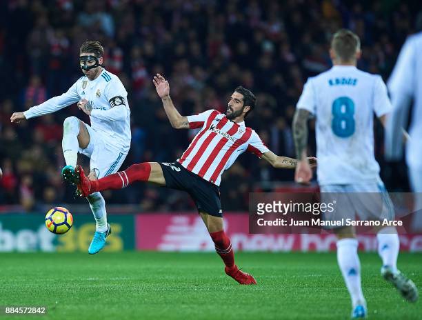 Sergio Ramos of Real Madrid CF competes for the ball with Raul Garcia of Athletic Club during the La Liga match between Athletic Club and Real Madrid...