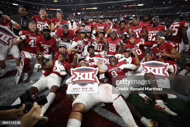 The Oklahoma Sooners pose for a team photo after winning the Big 12 Championship against the TCU Horned Frogs 41-17 at AT&T Stadium on December 2,...