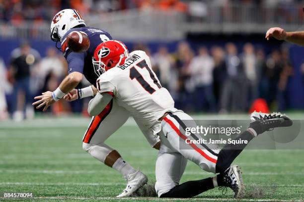Davin Bellamy of the Georgia Bulldogs forces a fumble by Jarrett Stidham of the Auburn Tigers during the first half in the SEC Championship at...