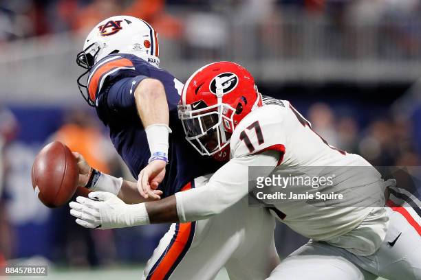 Davin Bellamy of the Georgia Bulldogs forces a fumble by Jarrett Stidham of the Auburn Tigers during the first half in the SEC Championship at...