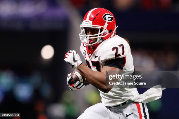 Nick Chubb of the Georgia Bulldogs runs the ball during the first half against the Auburn Tigers in the SEC Championship at Mercedes-Benz Stadium on...
