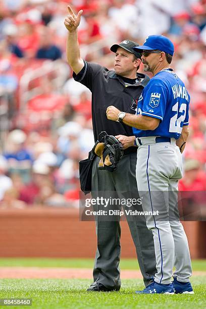 Home plate umpire Chris Guccione signals to the bullpen with manger Trey Hillman of the Kansas City Royals against the St. Louis Cardinals on May 23,...