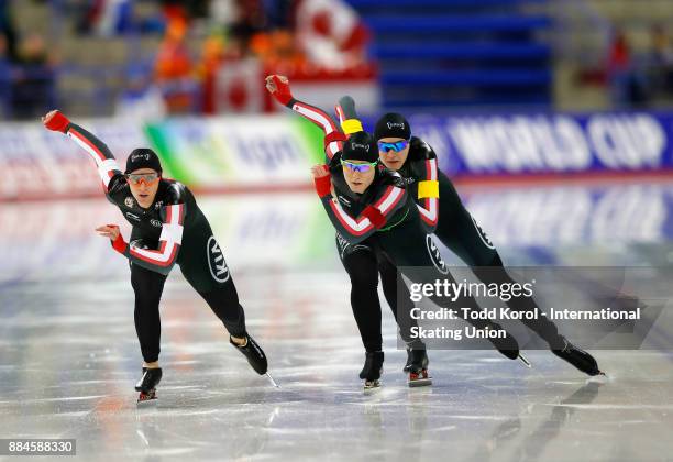 Ivanie Blondin , Kali Christ and Isabelle Weidemann of Canada race to a third place finish in the women's team pursuit during the ISU World Cup Speed...