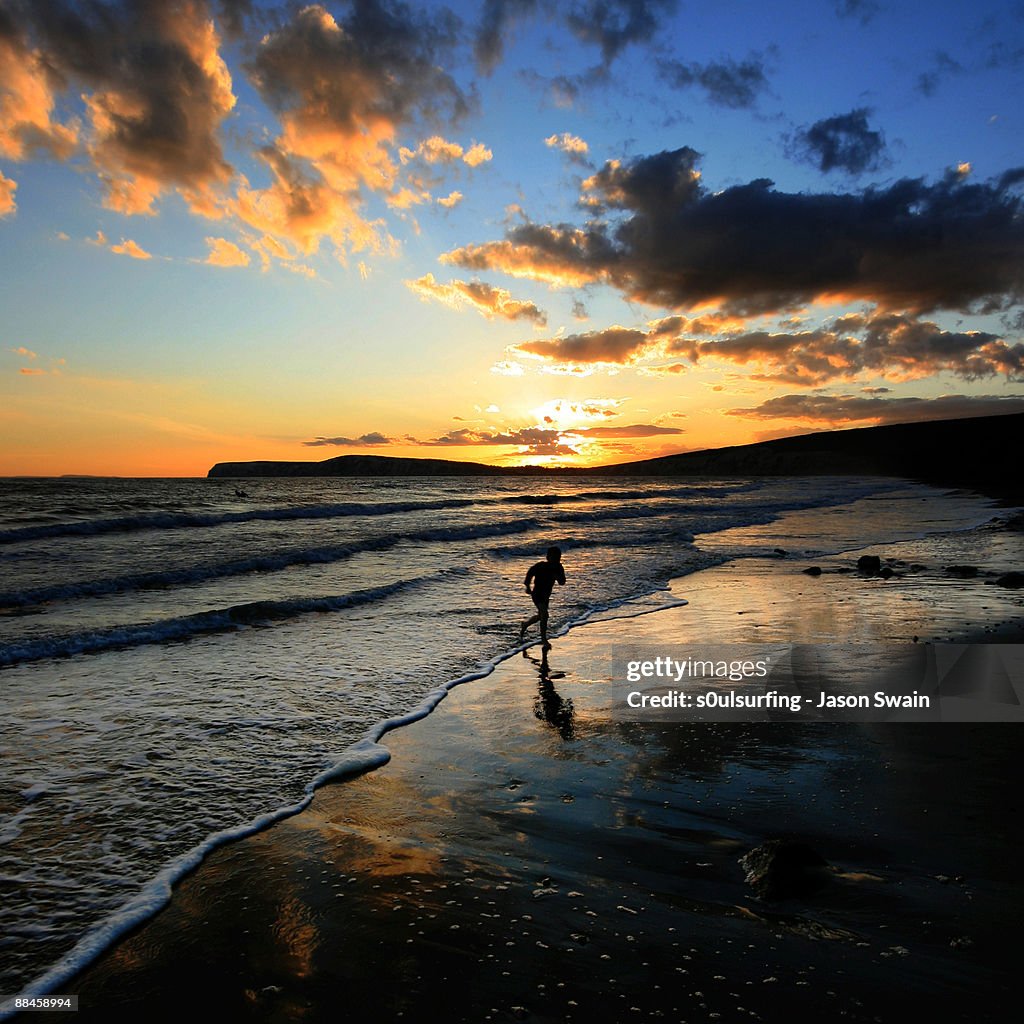 Playing  on coast at sunset 