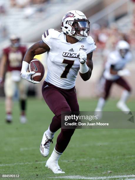 Linebacker Cortez Sisco, Jr. #7 of the Louisiana Monroe Warhawks runs back an interception during the game against the Florida State Seminoles at...