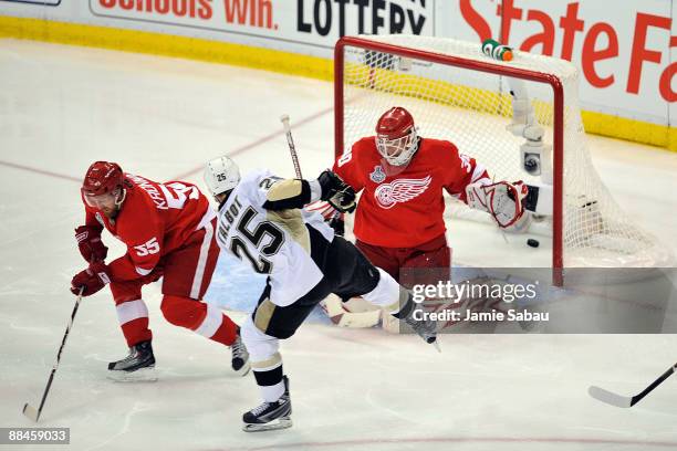 Maxime Talbot of the Pittsburgh Penguins scores a goal in the second period against Niklas Kronwall and Chris Osgood of the Detroit Red Wings during...