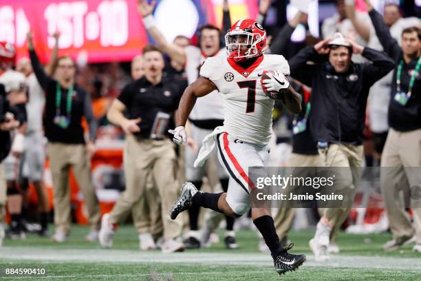 Andre Swift of the Georgia Bulldogs breaks away for a long touchdown run during the second half against the Auburn Tigers in the SEC Championship at...