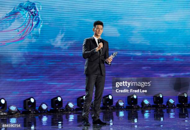 Chinese swimmer Sun Yang poses after receiving "The Special Award for Outstanding Contrbution Swimming Popularity in China" award at the 2017...