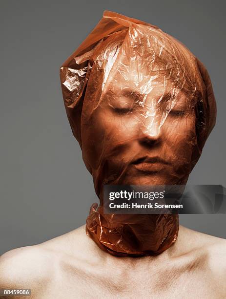 young woman with plastic bag over her head - suffocated stock pictures, royalty-free photos & images