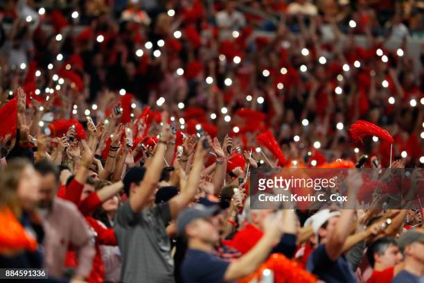 Fans turn on their phone flashlights to signal the start of the fourth quarter during the SEC Championship between the Georgia Bulldogs and the...