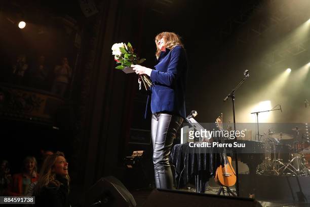 Singer Carla Bruni receives flowers from fan atb the end of her show at Le Trianon on December 2, 2017 in Paris, France.