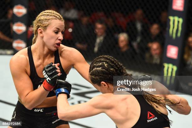 Amanda Cooper punches Angela Magana in their women's strawweight bout during the UFC 218 event inside Little Caesars Arena on December 02, 2017 in...