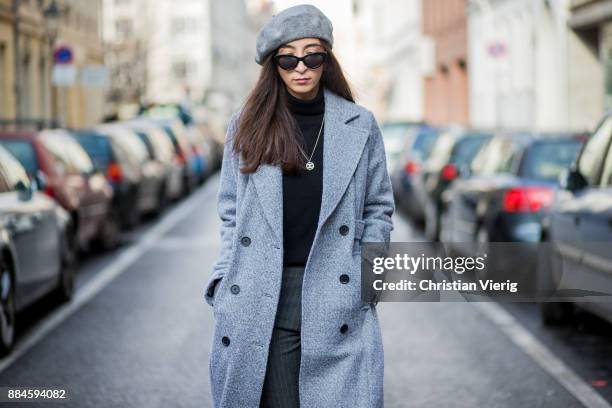 Nadia Ali wearing grey beret Zara, Mango sunglasses, a grey coat Mint & Berry, black turtleneck Repeat Cashmere, grey pants Zara, black Vans...