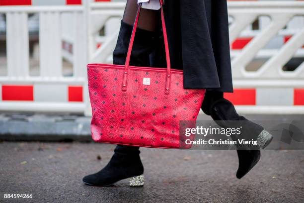 Nadia Ali wearing black Celine sunglasses, Chanel earrings, red knit Drykorn, white boyfriend button shirt Van Laack, black overknee boots Mint &...