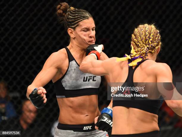 Felice Herrig punches Cortney Casey in their women's strawweight bout during the UFC 218 event inside Little Caesars Arena on December 02, 2017 in...