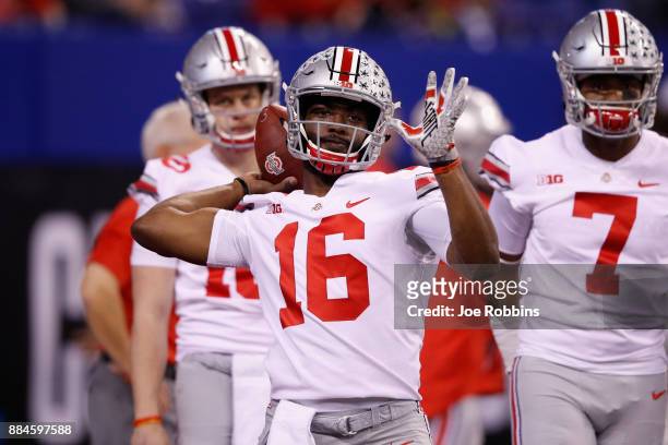 Quarterback J.T. Barrett of the Ohio State Buckeyes looks to pass while warming up before taking on the Wisconsin Badgers in the Big Ten Championship...