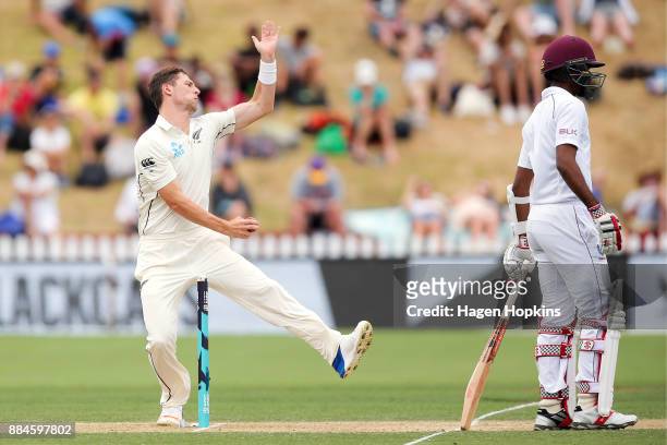 Matt Henry of New Zealand bowls while Kraigg Brathwaite of the West Indies looks on during day three of the Test match series between New Zealand...