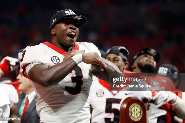 Roquan Smith of the Georgia Bulldogs reacts to winning the game MVP trophy after beating the Auburn Tigers in the SEC Championship at Mercedes-Benz...