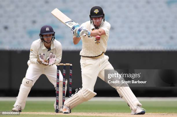 William Bosisto of Western Australia bats as wicketkeeper Seb Gotch of Victoria looks on during day one of the Sheffield Shield match between...