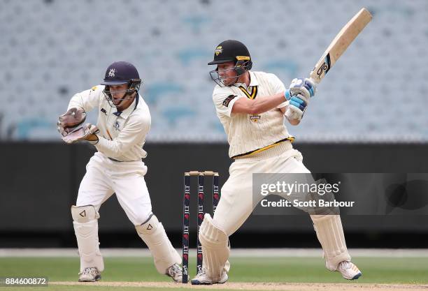 William Bosisto of Western Australia bats as wicketkeeper Seb Gotch of Victoria looks on during day one of the Sheffield Shield match between...