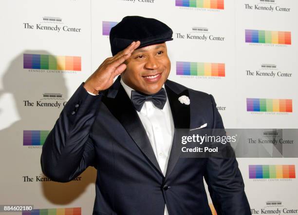 Cool J salutes as he arrives for the formal Artist's Dinner honoring the recipients of the 40th Annual Kennedy Center Honors hosted by United States...