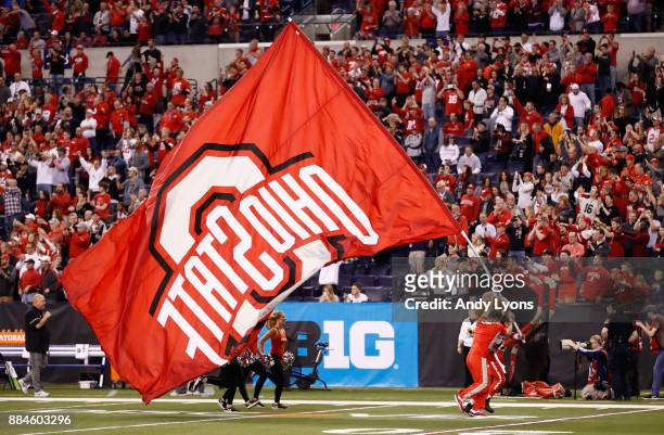 The Ohio State Buckeyes cheerleaders perform holding a flag while playing against the Wisconsin Badgers during the Big Ten Championship game at Lucas...