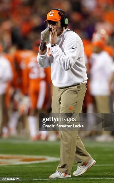 Head coach Dabo Swinney of the Clemson Tigers looks on against the Miami Hurricanes in the first half during the ACC Football Championship at Bank of...