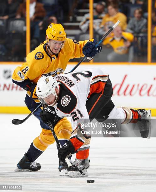 Kyle Turris of the Nashville Predators battles for the puck against Chris Wagner of the Anaheim Ducks during an NHL game at Bridgestone Arena on...
