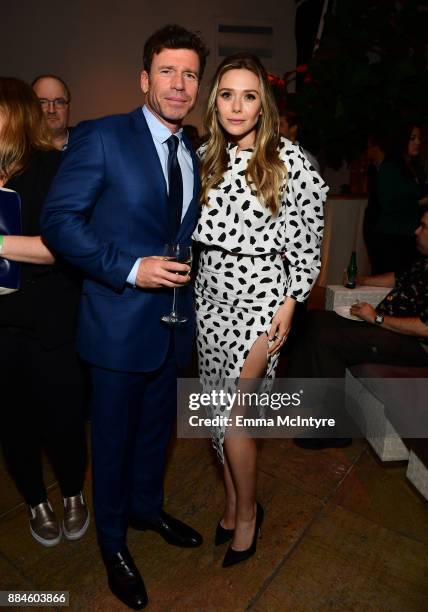 Writer/director Taylor Sheridan and actor Elizabeth Olsen attend a cocktail party for "Wind River" at Circa 55 Restaurant on December 2, 2017 in Los...