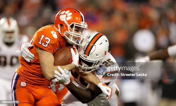 Hunter Renfrow of the Clemson Tigers runs the ball against Derrick Smith of the Miami Hurricanes in the second quarter during the ACC Football...