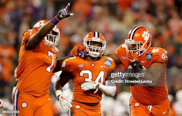 Kendall Joseph celebrates with teammates Austin Bryant and Christian Wilkins of the Clemson Tigers after an interception against the Miami Hurricanes...