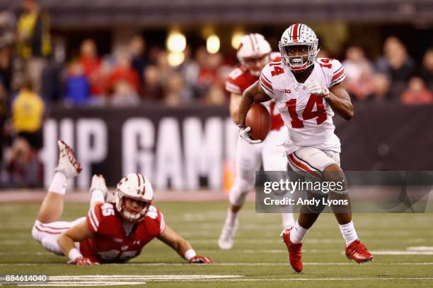 Wide receiver K.J. Hill of the Ohio State Buckeyes runs the ball against fullback Alec Ingold of the Wisconsin Badgers in the second half during the...