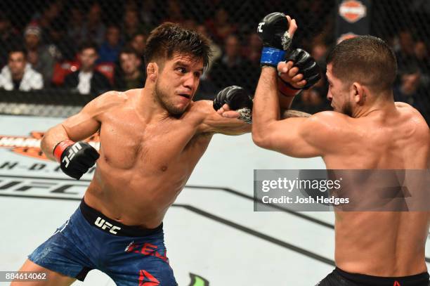 Henry Cejudo punches Sergio Pettis in their flyweight bout during the UFC 218 event inside Little Caesars Arena on December 02, 2017 in Detroit,...