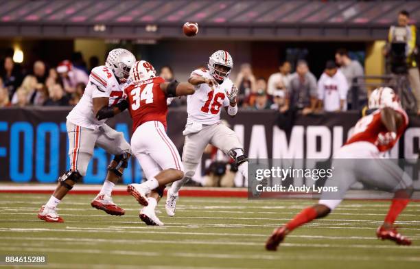 Quarterback J.T. Barrett of the Ohio State Buckeyes throws a pass against the Wisconsin Badgers during the Big Ten Championship game at Lucas Oil...