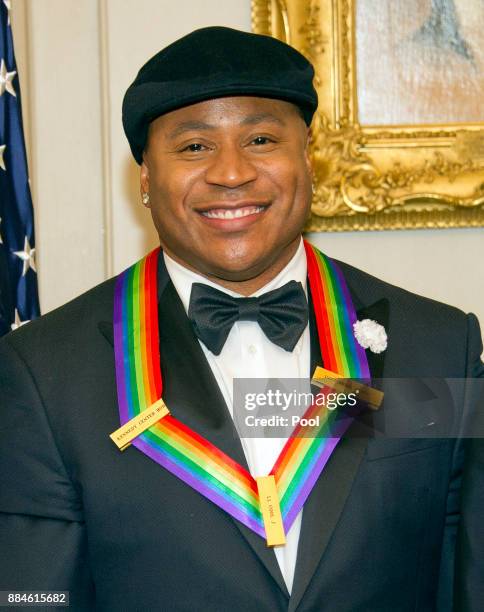 One of he five recipients of the 40th Annual Kennedy Center Honors with his award as he poses for a group photo following a dinner hosted by United...