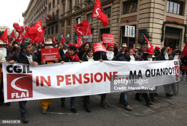 People take part in a demonstration called by the General Confederation of Labor to protest against the government in defense of pensions on December...