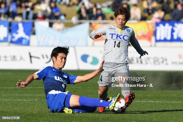 Kazuki Nishiya of Tochigi SC is tackled by Yuta Kutsukake of Azul Claro Numazu during the J.League J3 match between Azul Claro Numazu and Tochigi SC...