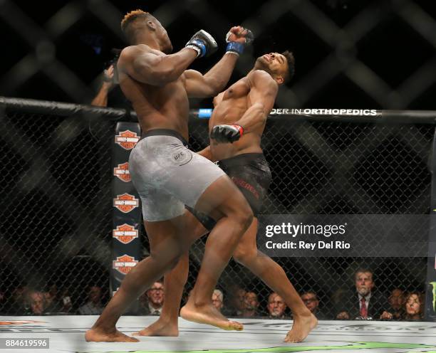 Francis Ngannou punches Alex Oliveira during the UFC 218 event at Little Caesars Arena on December 2, 2017 in Detroit, Michigan.